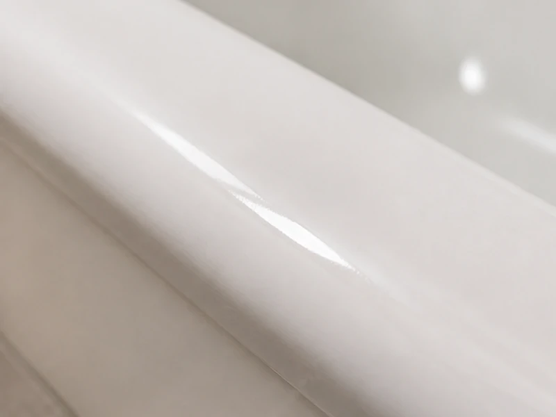 Repaired and sealed chip on a smooth white bathtub rim in a Birdland home, Sunnyvale